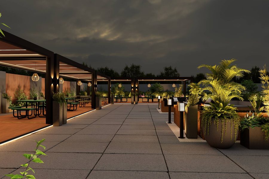 Dining tables and planting on the Robata Albany patio at night
